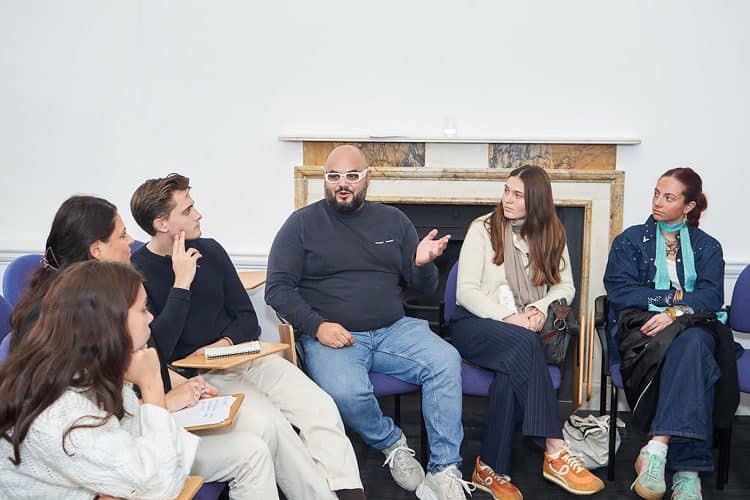 Mustafa Himdi speaking with students at Vogue College in London